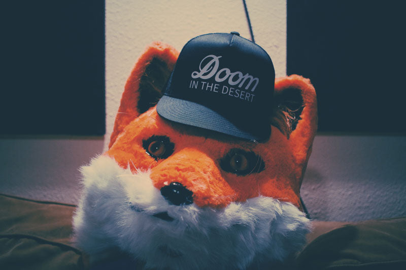 Fox wearing a Doom In The Desert cap